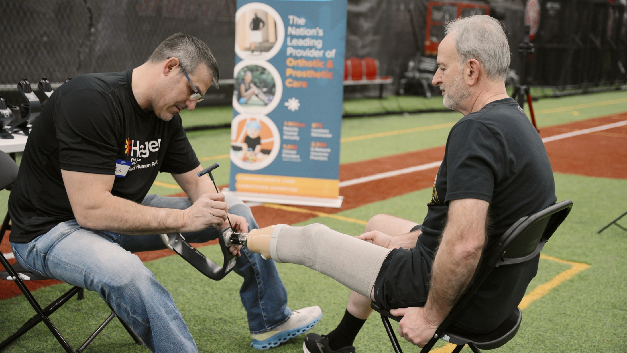 Prosthetist fitting a Levitate prosthetic blade for a patient at a clinical event
